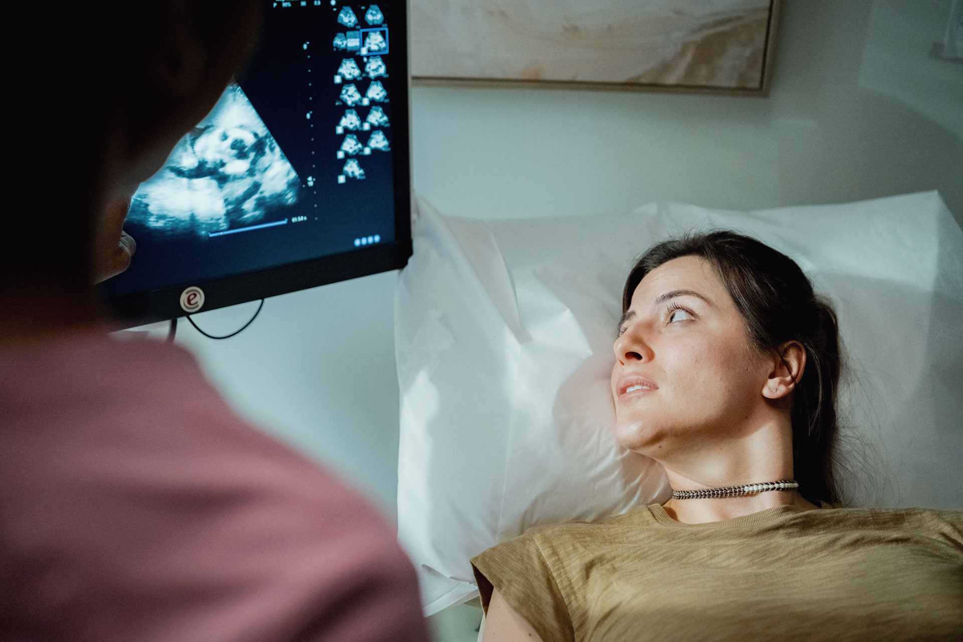 Nurse looking at ultrasound with female patient