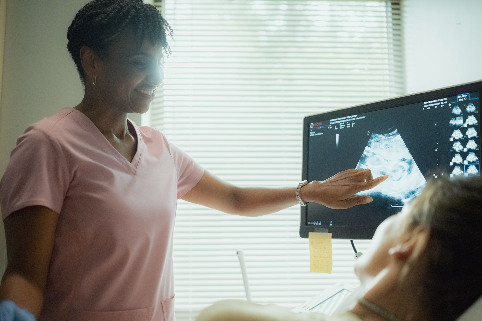 Nurse looking at ultrasound with female patient